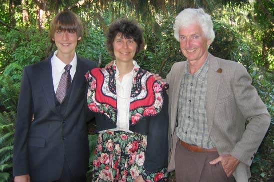 Rosemarie and Pat with their son at a school graduation ceremony. Rosemarie now a curly head - natural curls.